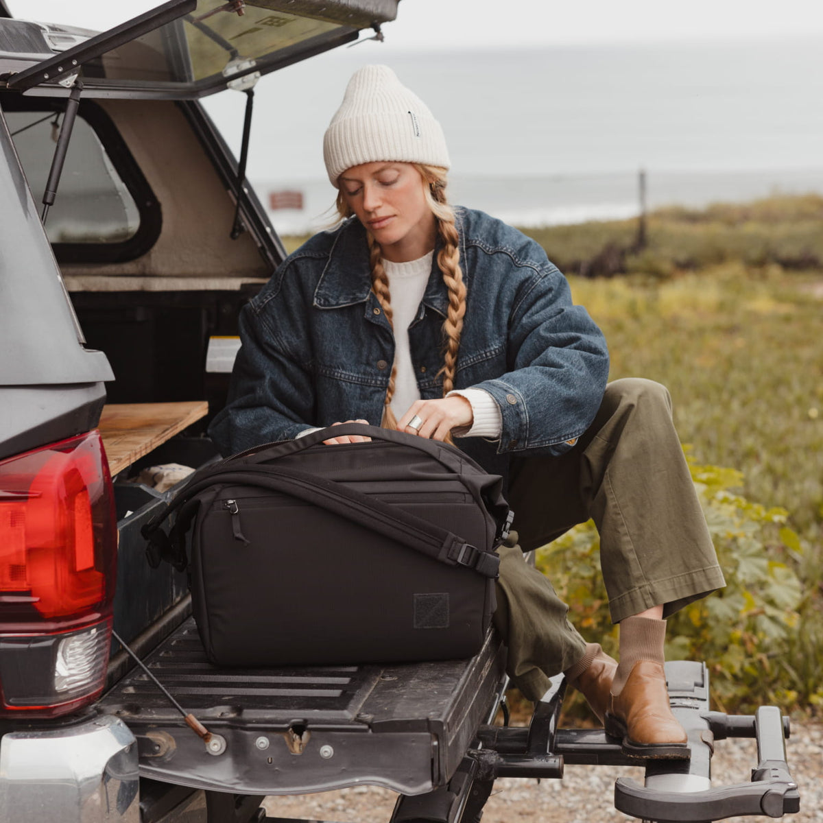 Transit Duffel 25L in Solution Dyed Black - back of truck for road trip Transit Duffel 25L in Solution Dyed Black - back of truck for road trip [13023d-SBK