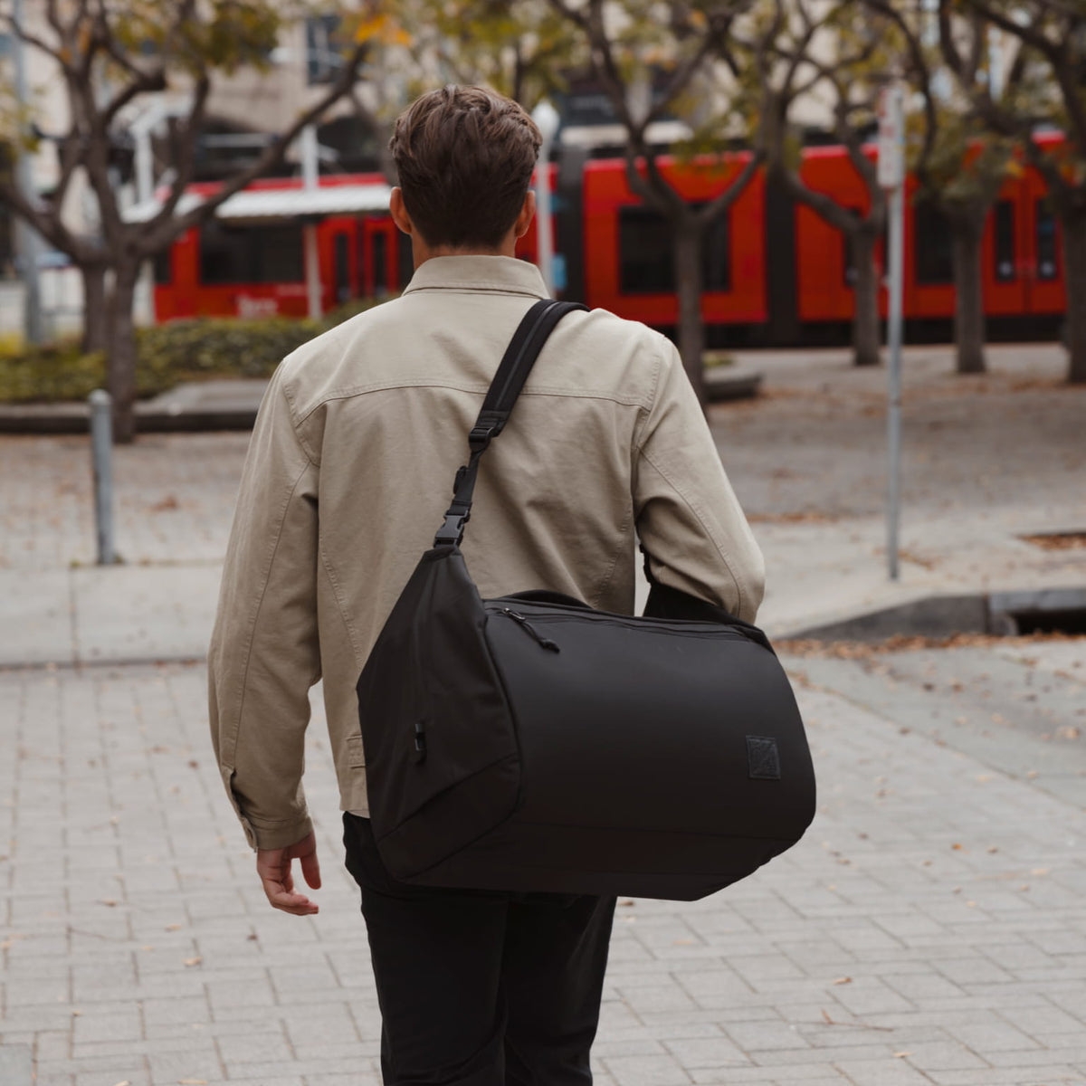 Transit Duffel 35L in Solution Dyed Black - over shoulder strap carry to train Transit Duffel 35L in Solution Dyed Black - over shoulder strap carry to train [13014d-SBK