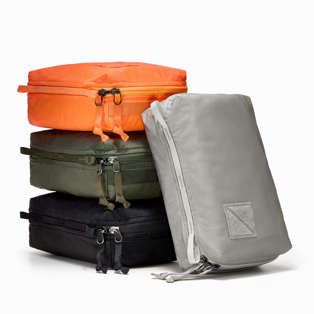 Transit Packing Cube 4L, stack of four cubes in Hot Orange, OD Green, Black, and Standard Gray Transit Packing Cube 4L, stack of four cubes in Hot Orange, OD Green, Black, and Standard Gray [13026a-BLK, 13026a-HTO, 13026a-ODG, 13026a-STG