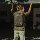 Woman wearing CIVIC Panel Loader 16L in a green vest and closing a garage door Woman wearing CIVIC Panel Loader 16L in a green vest and closing a garage door [13016cc-WTN