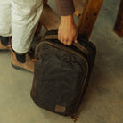 CIVIC Panel Loader 16L in waxed tan - top handle grabbed in a garage CIVIC Panel Loader 16L in waxed tan - top handle grabbed in a garage [13016cc-WTN