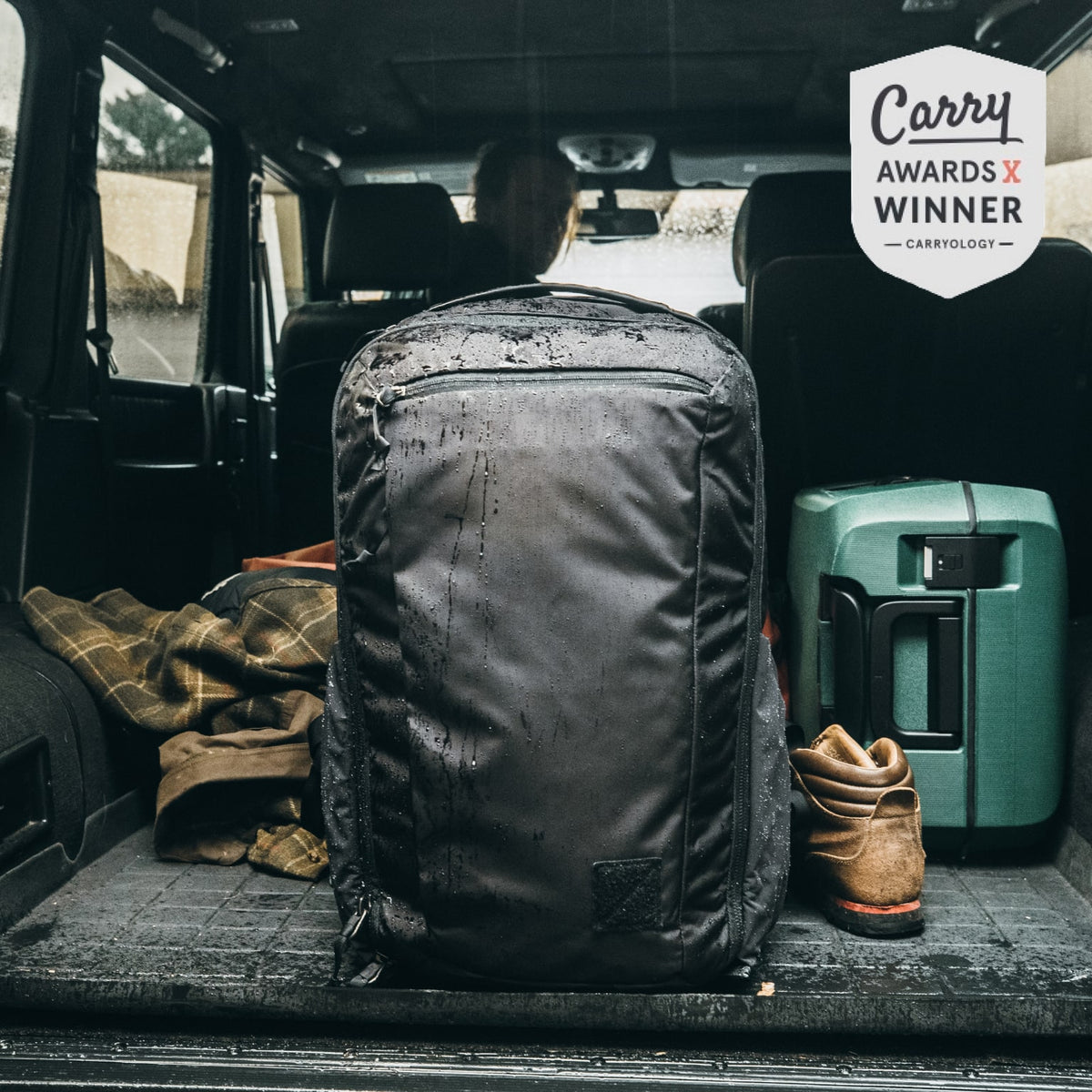 CIVIC Travel Bag 35L in solution dyed black back of truck