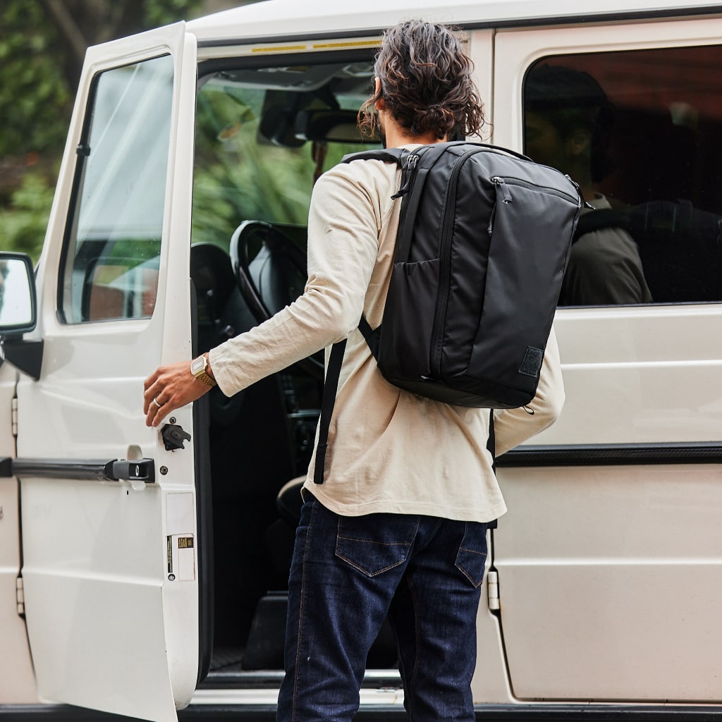 CIVIC Travel Bag 20L in Solution Dyed Black - worn while entering car
