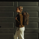 CIVIC Travel Bag 20L in Waxed Canvas - Waxed Tan - size from side view - Model Height 5'7" 170cm CIVIC Travel Bag 20L in Waxed Canvas - Waxed Tan - size from side view - Model Height 5'7" 170cm [13019cc-WTN
