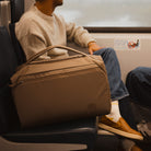 Transit Duffel 35L in Fossil Brown carried on a train Transit Duffel 35L in Fossil Brown carried on a train [13014d-FBN