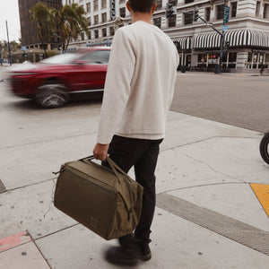 Transit Duffel 35L in OD Green street crossing [13014d-ODG]