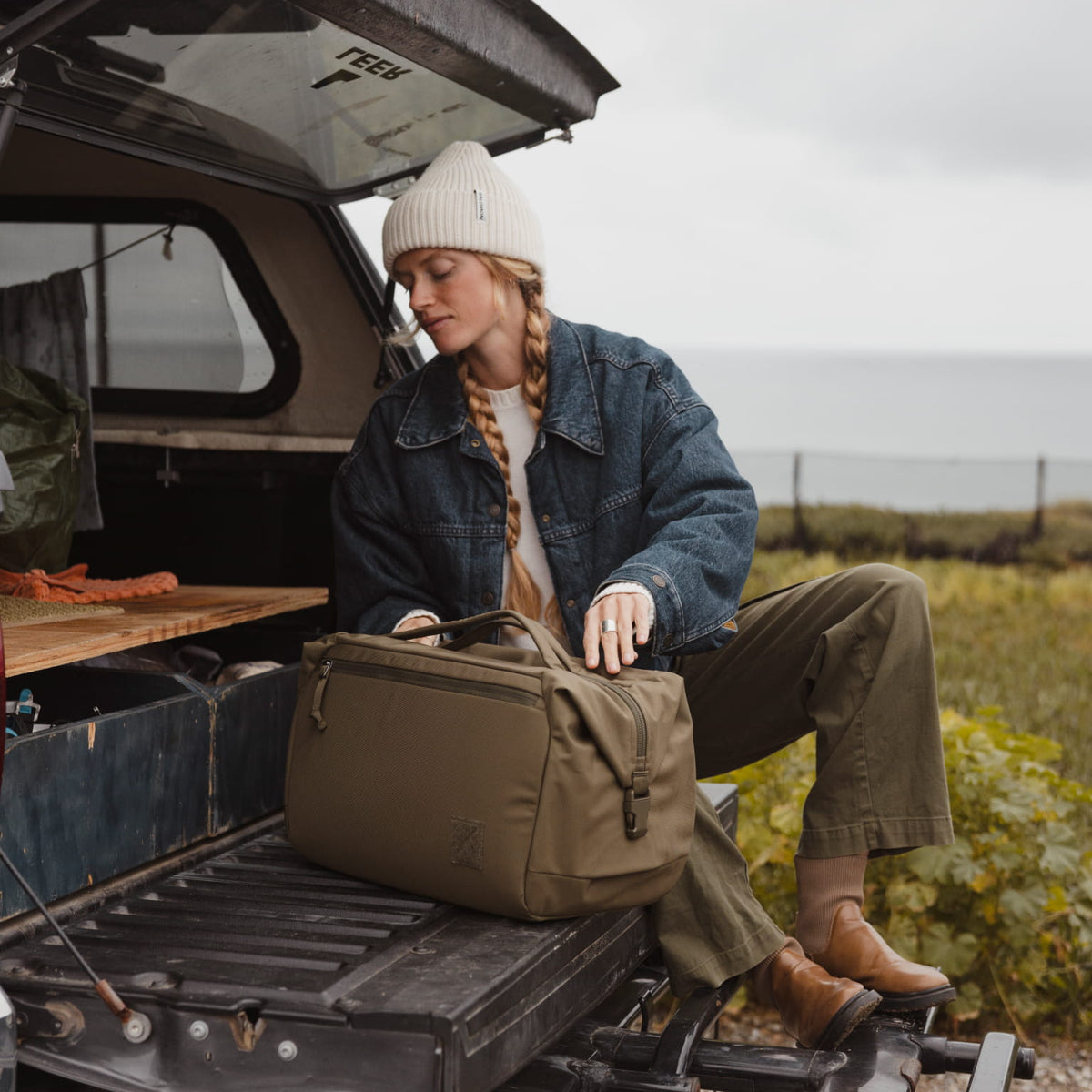 Transit Duffel 35L in OD Green used on the back of a truck road trip [13014d-ODG]