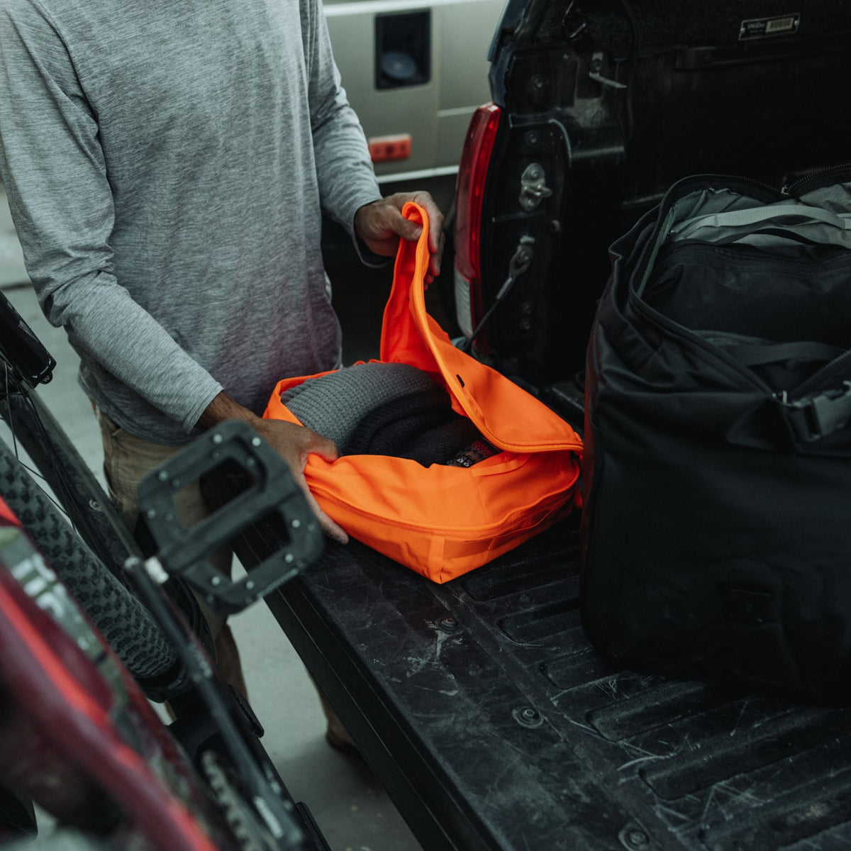 Transit Packing Cube 10L in Hot Orange - opening and packed with clothes [13021a-HTO]