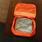 Transit Packing Cube 10L in Hot Orange - packed with pants Transit Packing Cube 10L in Hot Orange - packed with pants [13021a-HTO