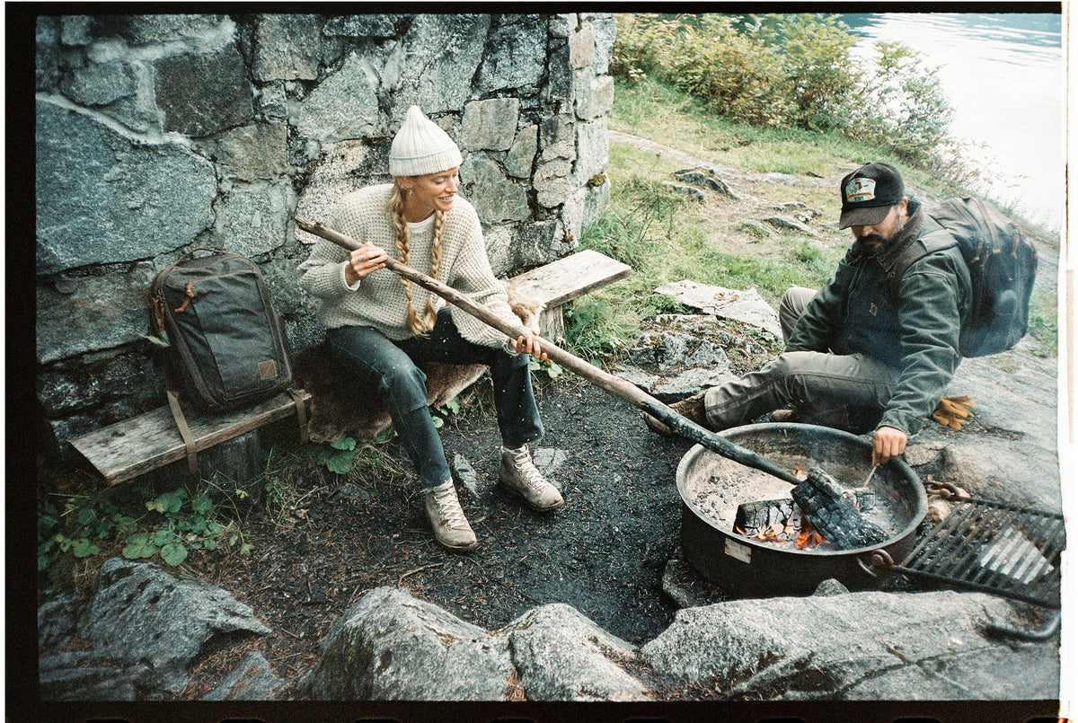 Alaska Waxed Canvas Behind the Scenes Tending to Fire at Cabin